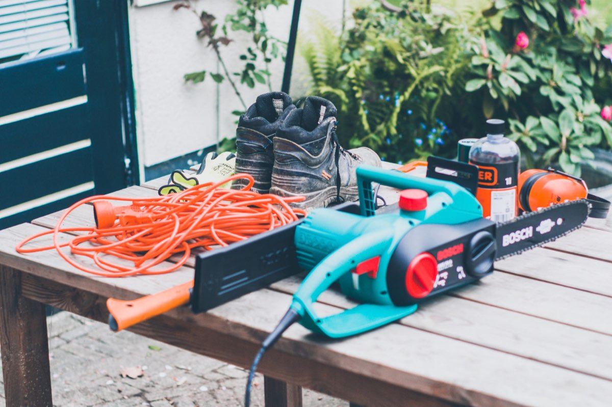 An electric chainsaw on a garden table